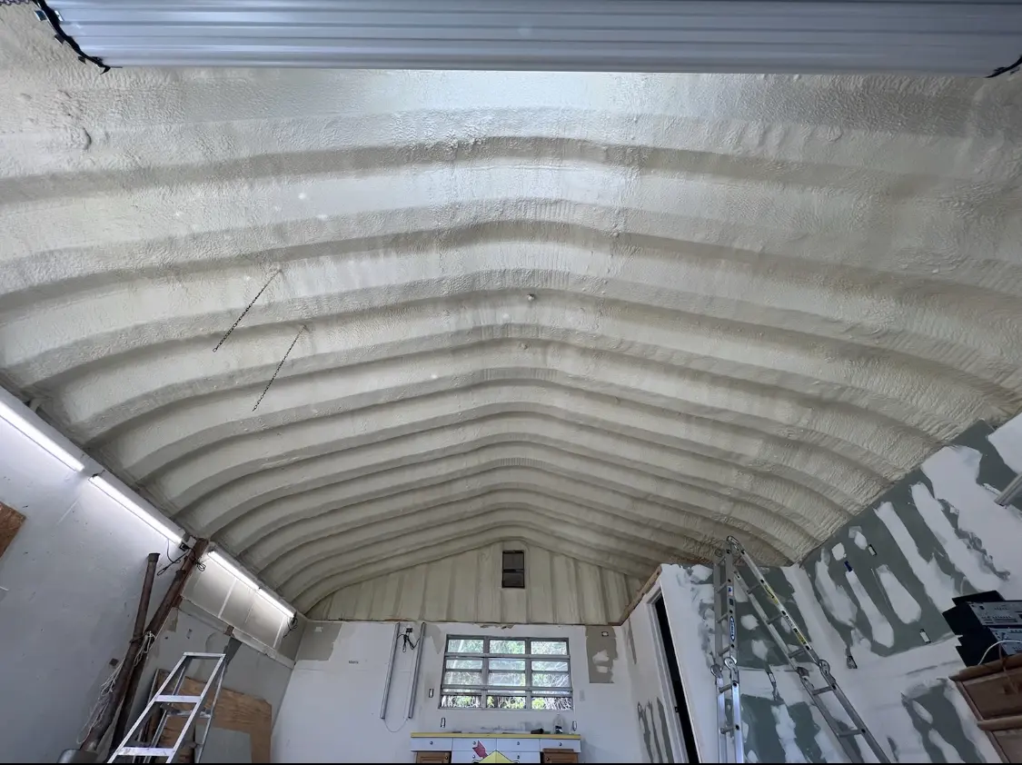 Spray polyurethane foam applied to the underside of a metal roof deck in Washington